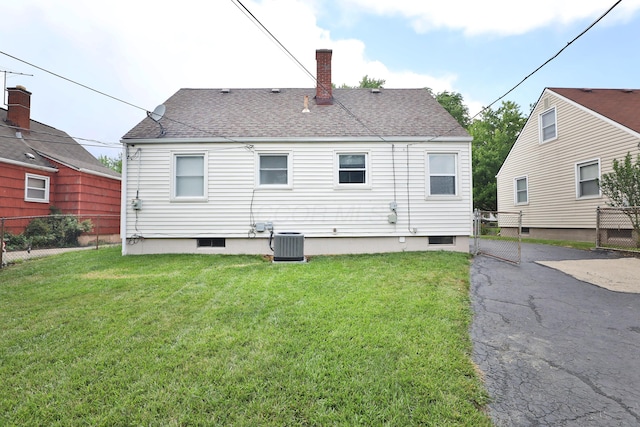 815 Eddystone Ave, Columbus, OH 43224 - back of house featuring a chimney, roof with shingles, and a gate