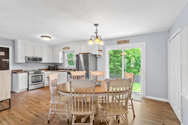11962 Joppa Rd, Logan, OH 43138 - dining room featuring light wood finished floors and a chandelier