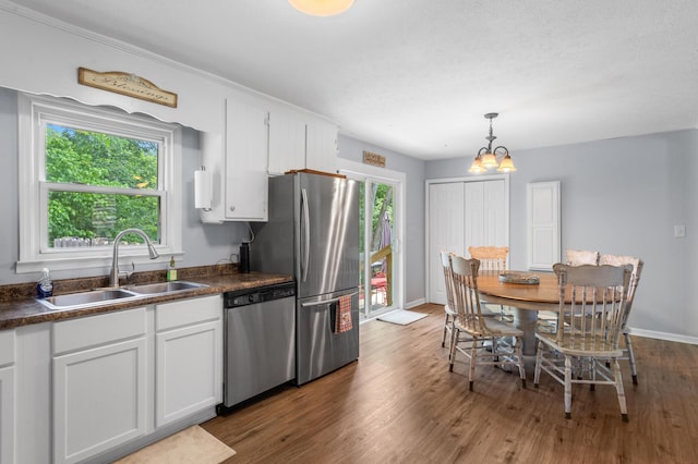 11962 Joppa Rd, Logan, OH 43138 - kitchen featuring stainless steel appliances, dark countertops, white cabinetry, and a chandelier