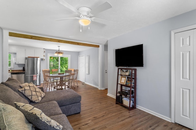 11962 Joppa Rd, Logan, OH 43138 - living room with dark wood-style flooring, a ceiling fan, beamed ceiling, and a chandelier