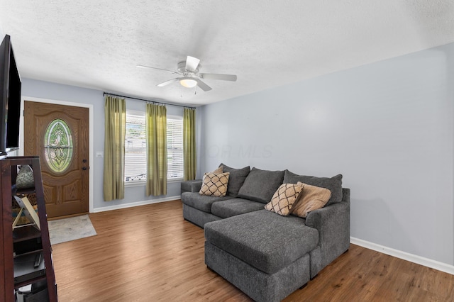 11962 Joppa Rd, Logan, OH 43138 - living area with ceiling fan, wood finished floors, and a textured ceiling