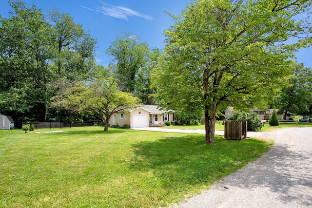 11962 Joppa Rd, Logan, OH 43138 - view of yard with driveway, an attached garage, and view of scattered trees