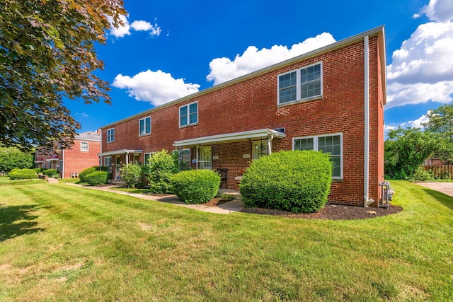 2043 Ridgeview Rd, Columbus, OH 43221 - rear view of house with brick siding and a lawn