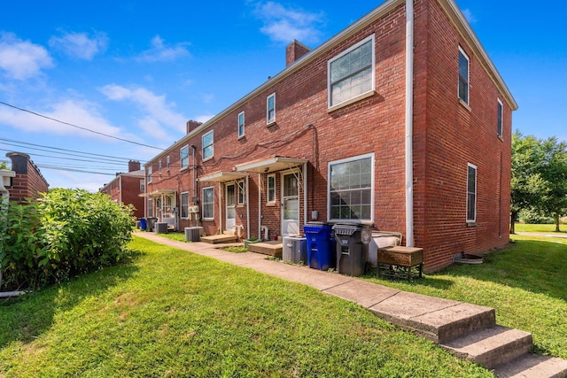 2043 Ridgeview Rd, Columbus, OH 43221 - rear view of property featuring brick siding, a yard, and a chimney