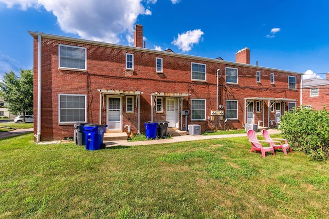 2043 Ridgeview Rd, Columbus, OH 43221 - rear view of house with a chimney, a yard, and brick siding