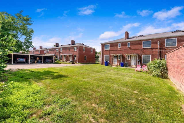 2043 Ridgeview Rd, Columbus, OH 43221 - rear view of house with a lawn, a chimney, and brick siding