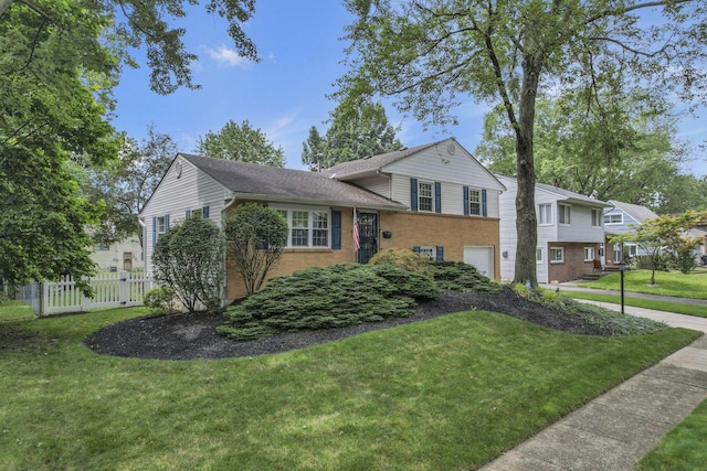 4861 Dickens Dr, Columbus, OH 43227 - split level home featuring an attached garage and brick siding