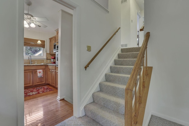 4861 Dickens Dr, Columbus, OH 43227 - stairs with wood finished floors and ceiling fan