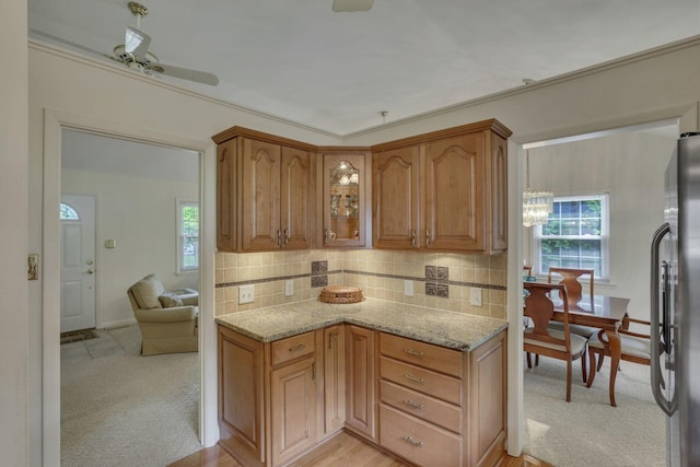 4861 Dickens Dr, Columbus, OH 43227 - kitchen with light stone counters, freestanding refrigerator, decorative backsplash, and healthy amount of natural light
