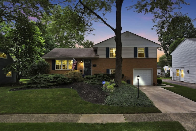 4861 Dickens Dr, Columbus, OH 43227 - split level home with concrete driveway, brick siding, and a garage