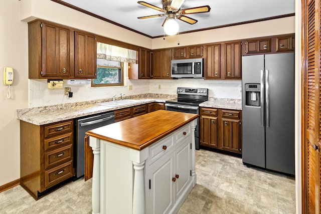 6983 Doran Dr, New Albany, OH 43054 - kitchen featuring appliances with stainless steel finishes, backsplash, a ceiling fan, a kitchen island, and crown molding