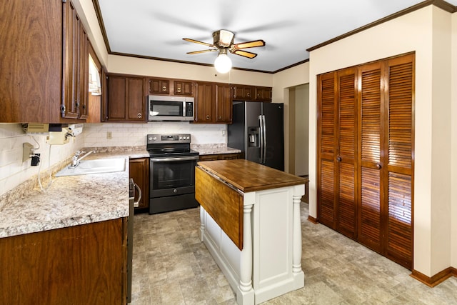 6983 Doran Dr, New Albany, OH 43054 - kitchen with stainless steel appliances, decorative backsplash, ceiling fan, ornamental molding, and a center island
