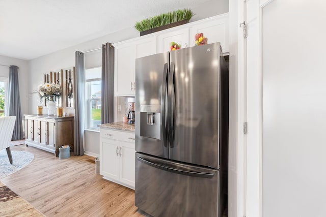 152 Natalie Ln, Granville, OH 43023 - kitchen with stainless steel fridge with ice dispenser, light wood-style flooring, white cabinets, and light stone countertops