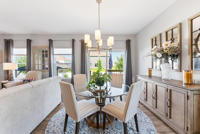 152 Natalie Ln, Granville, OH 43023 - dining space with a chandelier, healthy amount of natural light, and light wood-style flooring