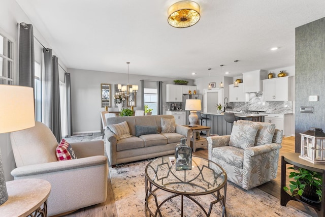 152 Natalie Ln, Granville, OH 43023 - living room with light wood finished floors, a chandelier, and recessed lighting