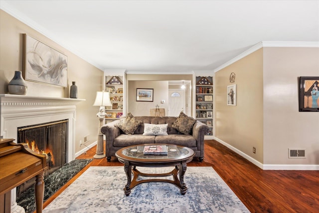 445 Hilltop Dr, Lancaster, OH 43130 - living area featuring built in features, wood finished floors, a lit fireplace, and crown molding