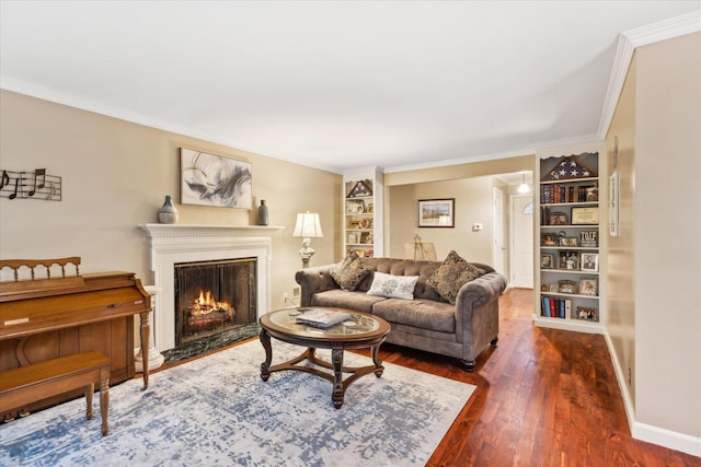 445 Hilltop Dr, Lancaster, OH 43130 - living room featuring wood-type flooring, built in shelves, a warm lit fireplace, and ornamental molding