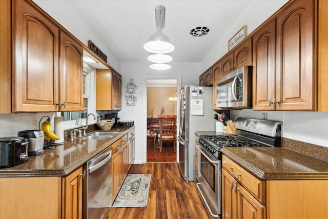 445 Hilltop Dr, Lancaster, OH 43130 - kitchen with appliances with stainless steel finishes, dark wood finished floors, brown cabinets, and dark stone counters