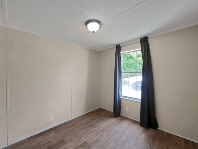 71 Biddle Blvd Unit 24, Bloomingburg, OH 43106 - unfurnished room with wood finished floors, a textured ceiling, and ornamental molding