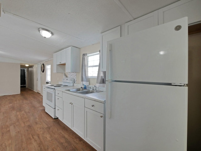 71 Biddle Blvd Unit 24, Bloomingburg, OH 43106 - kitchen with white appliances, light countertops, white cabinets, wood finished floors, and lofted ceiling