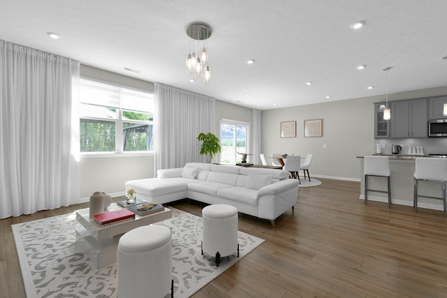 1180 Lake Forest Dr, Hebron, OH 43025 - living room featuring wood finished floors, recessed lighting, and a chandelier