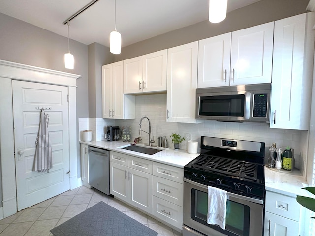 252 W Hubbard Ave, Columbus, OH 43215 - kitchen featuring appliances with stainless steel finishes, backsplash, and white cabinets