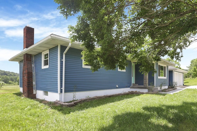 39703 Maysville Greendale Rd, Logan, OH 43138 - view of front facade with a chimney, a front yard, and a garage