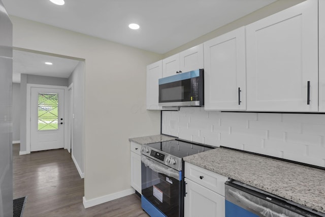 39703 Maysville Greendale Rd, Logan, OH 43138 - kitchen featuring appliances with stainless steel finishes, tasteful backsplash, wood finished floors, white cabinets, and recessed lighting