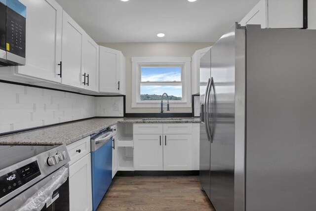 39703 Maysville Greendale Rd, Logan, OH 43138 - kitchen with stainless steel appliances, recessed lighting, white cabinets, dark wood-style flooring, and light stone counters