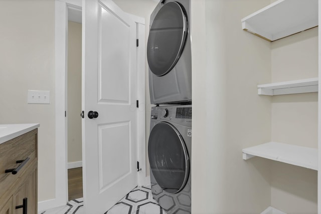 39703 Maysville Greendale Rd, Logan, OH 43138 - washroom featuring estacked washer and dryer and baseboards