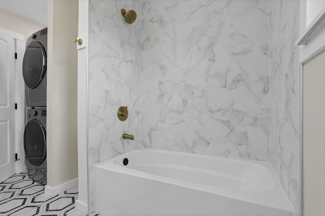 39703 Maysville Greendale Rd, Logan, OH 43138 - bathroom featuring stacked washing machine and dryer, shower / tub combination, and tile patterned floors