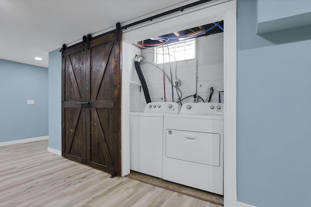 39703 Maysville Greendale Rd, Logan, OH 43138 - laundry area with separate washer and dryer, light wood-style floors, a barn door, and recessed lighting