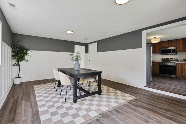 101 Circle Dr, Baltimore, OH 43105 - dining room featuring a decorative wall, dark wood-style flooring, and wainscoting