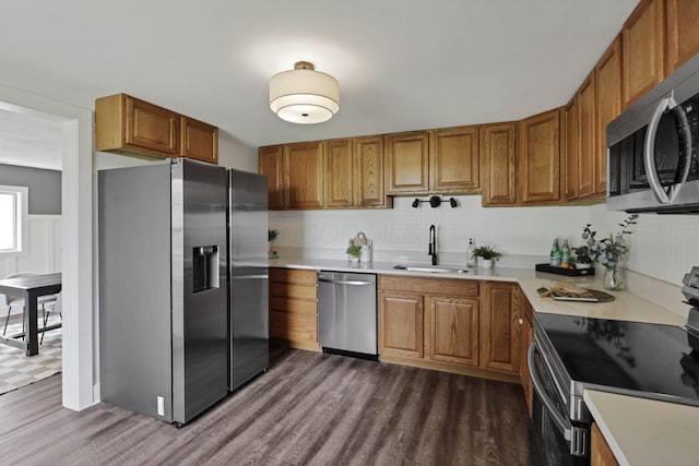 101 Circle Dr, Baltimore, OH 43105 - kitchen with appliances with stainless steel finishes, dark wood-style flooring, brown cabinets, and light countertops
