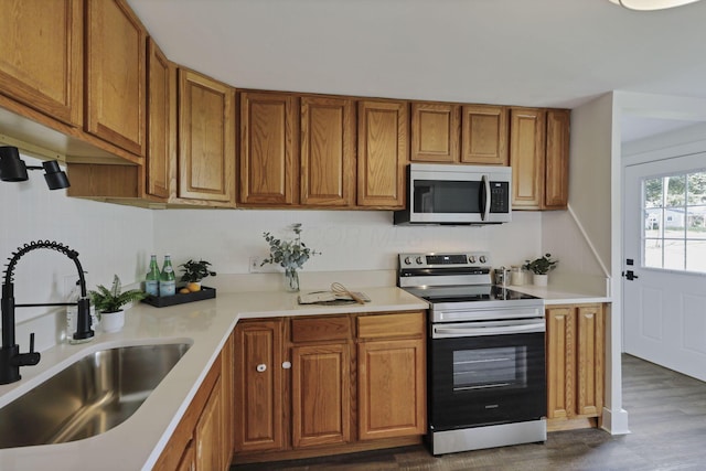 101 Circle Dr, Baltimore, OH 43105 - kitchen featuring stainless steel appliances, brown cabinetry, light countertops, and dark wood-type flooring