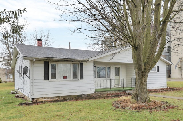 210 S Front St, Alger, OH 45812 - ranch-style house with a chimney, a front yard, roof with shingles, and covered porch