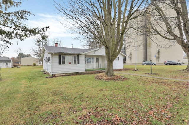 210 S Front St, Alger, OH 45812 - view of front of house featuring a chimney, a front lawn, and roof with shingles