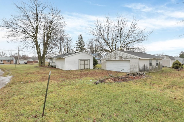 210 S Front St, Alger, OH 45812 - view of grassy yard featuring a detached garage and an outbuilding