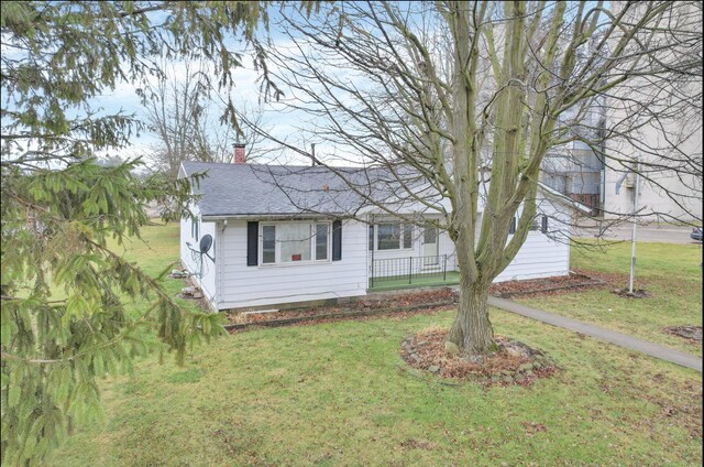 210 S Front St, Alger, OH 45812 - view of front of home featuring a chimney, a shingled roof, and a front lawn