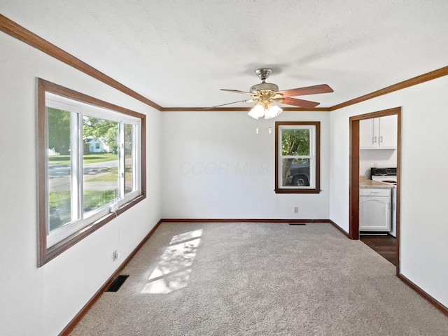264 Lawrence Ave, Columbus, OH 43228 - carpeted spare room with washer / clothes dryer, a ceiling fan, crown molding, and a textured ceiling