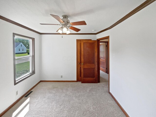 264 Lawrence Ave, Columbus, OH 43228 - unfurnished room with light colored carpet, crown molding, and a ceiling fan