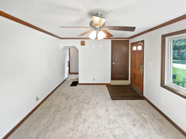 264 Lawrence Ave, Columbus, OH 43228 - carpeted empty room featuring ceiling fan, arched walkways, and ornamental molding