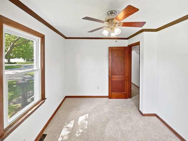 264 Lawrence Ave, Columbus, OH 43228 - spare room featuring light carpet, ornamental molding, and a ceiling fan