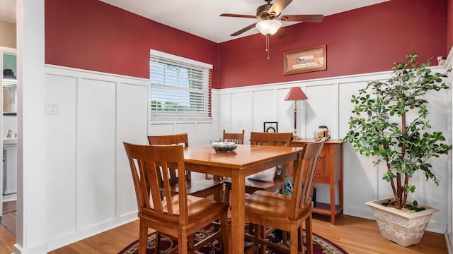 452 Jefferson Rd, Newark, OH 43055 - dining space with a decorative wall, light wood finished floors, a ceiling fan, and wainscoting