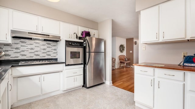 452 Jefferson Rd, Newark, OH 43055 - kitchen featuring stainless steel appliances, under cabinet range hood, tasteful backsplash, and white cabinetry