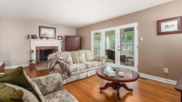 452 Jefferson Rd, Newark, OH 43055 - living area with french doors, a brick fireplace, and wood finished floors