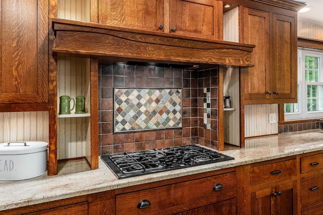 8622 Lott Rd, Marengo, OH 43334 - kitchen with black gas cooktop, backsplash, light stone counters, and brown cabinets