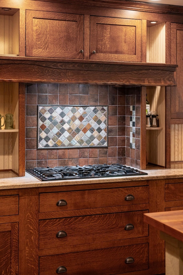 8622 Lott Rd, Marengo, OH 43334 - kitchen with black gas stovetop, tasteful backsplash, brown cabinets, and light countertops