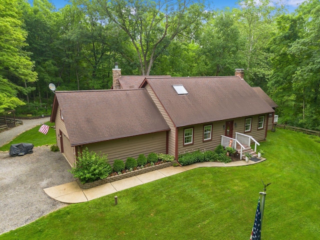 8622 Lott Rd, Marengo, OH 43334 - view of front of house featuring a chimney, roof with shingles, a front yard, and driveway