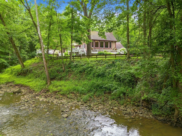 8622 Lott Rd, Marengo, OH 43334 - back of house featuring a shingled roof, a water view, and a wooded view